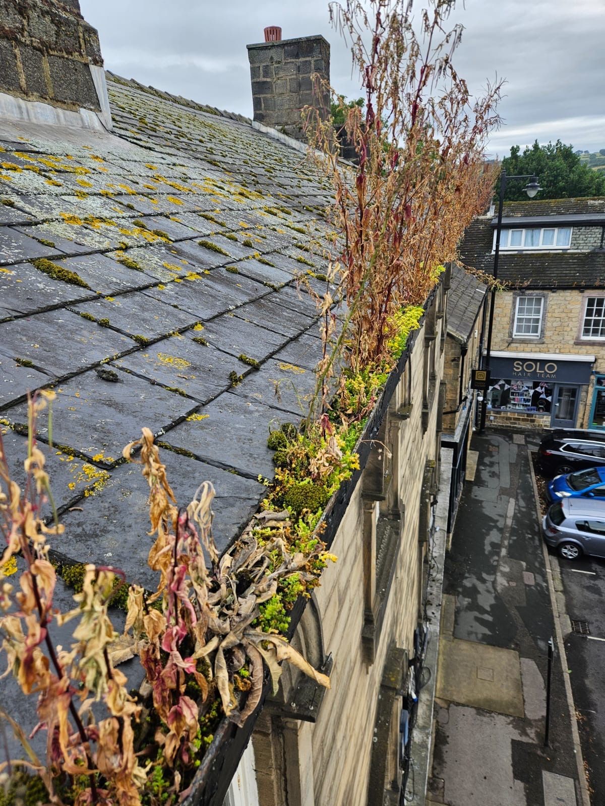 Before: town-centre stone building gutter blocked