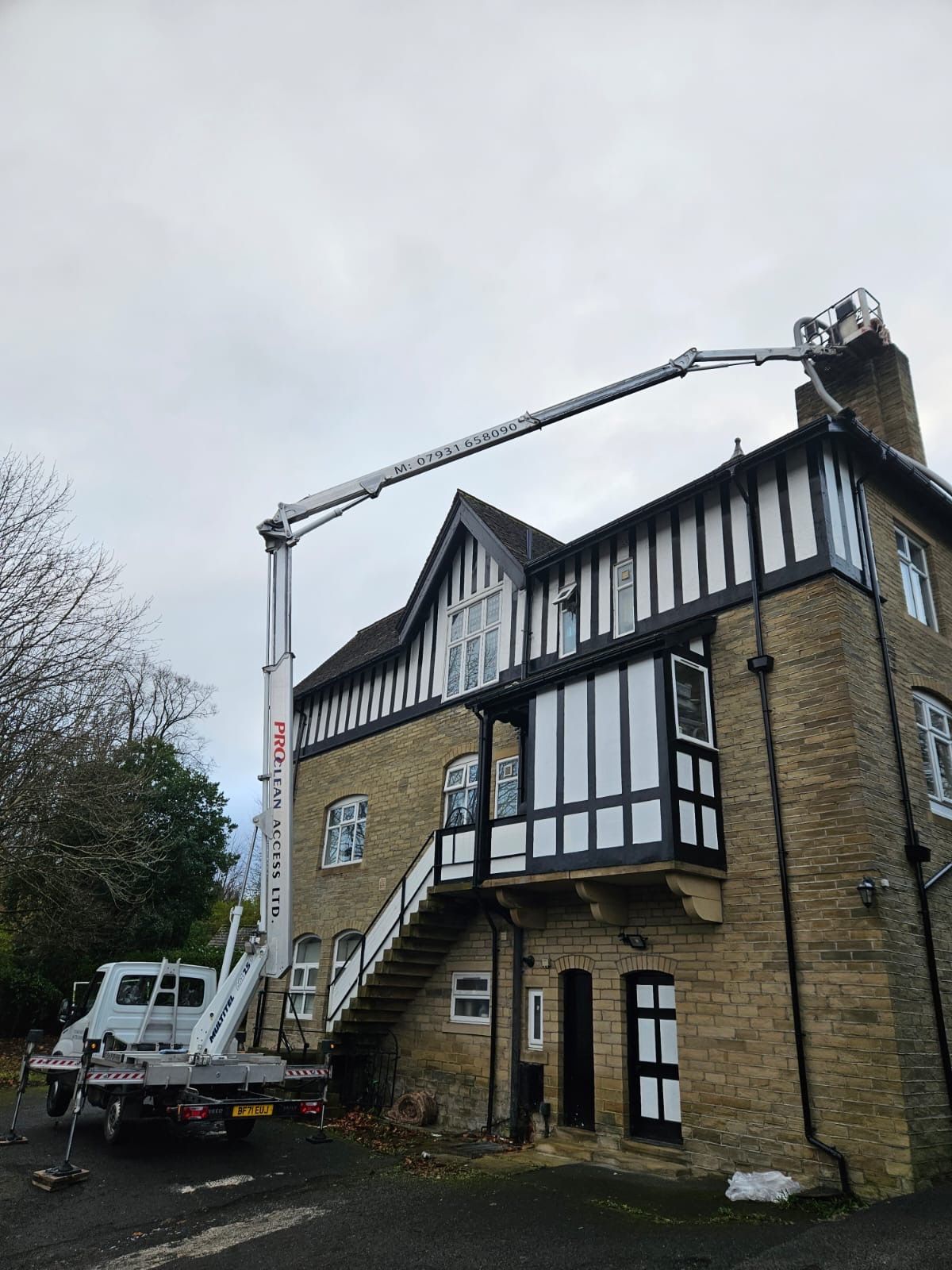 Cherry picker at large period stone property with balcony