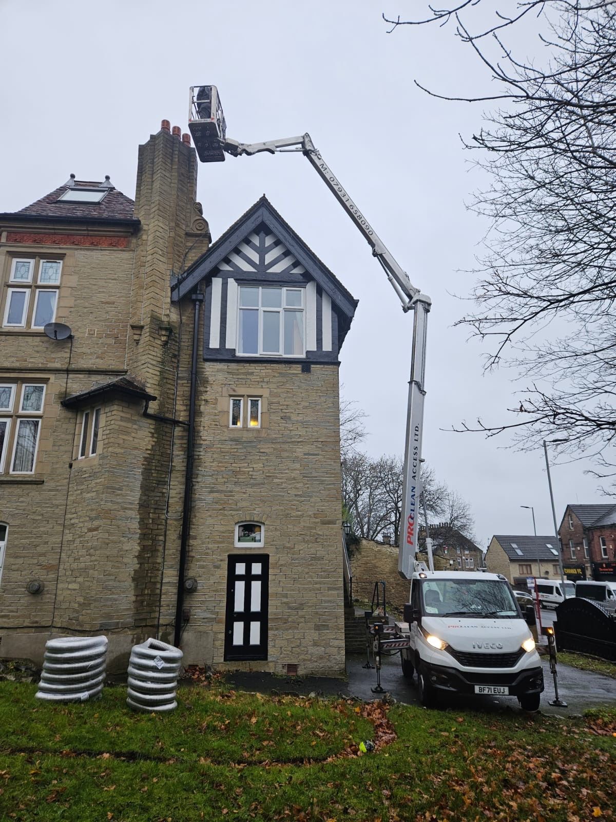 ProClean Access cherry picker at tall stone Victorian property in winter