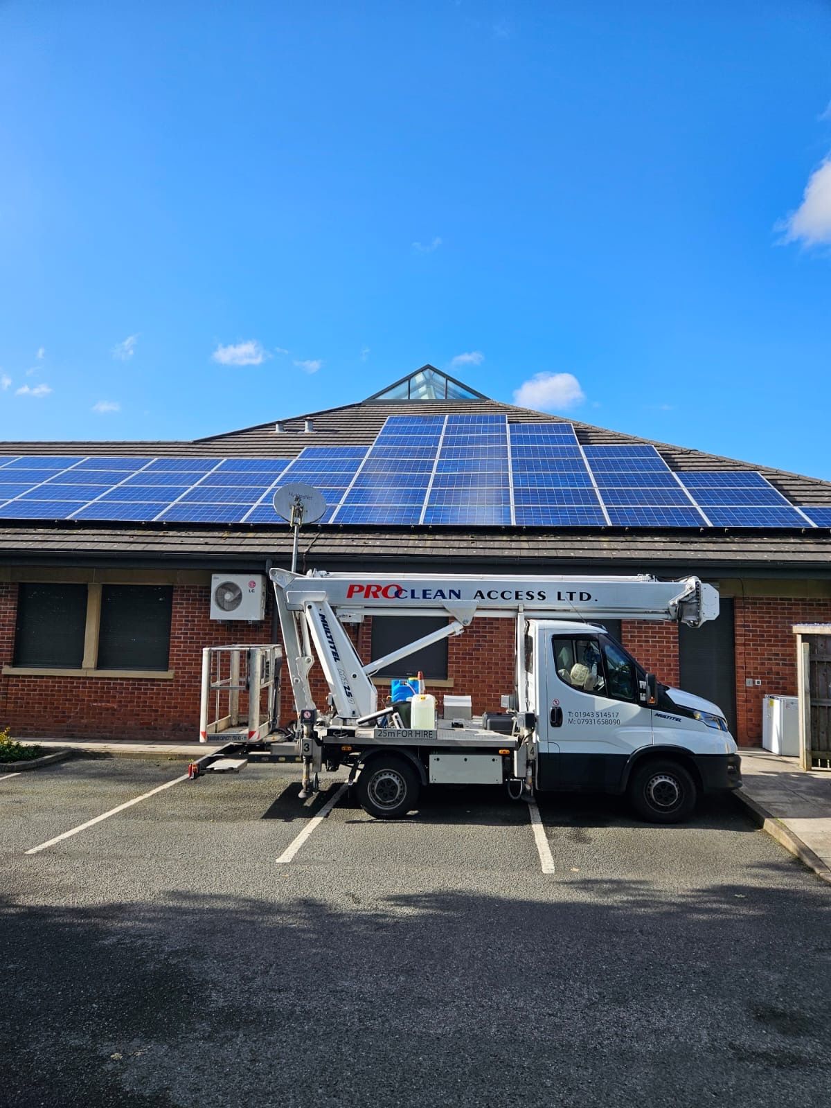 ProClean Access truck-mounted cherry picker at commercial solar panel installation